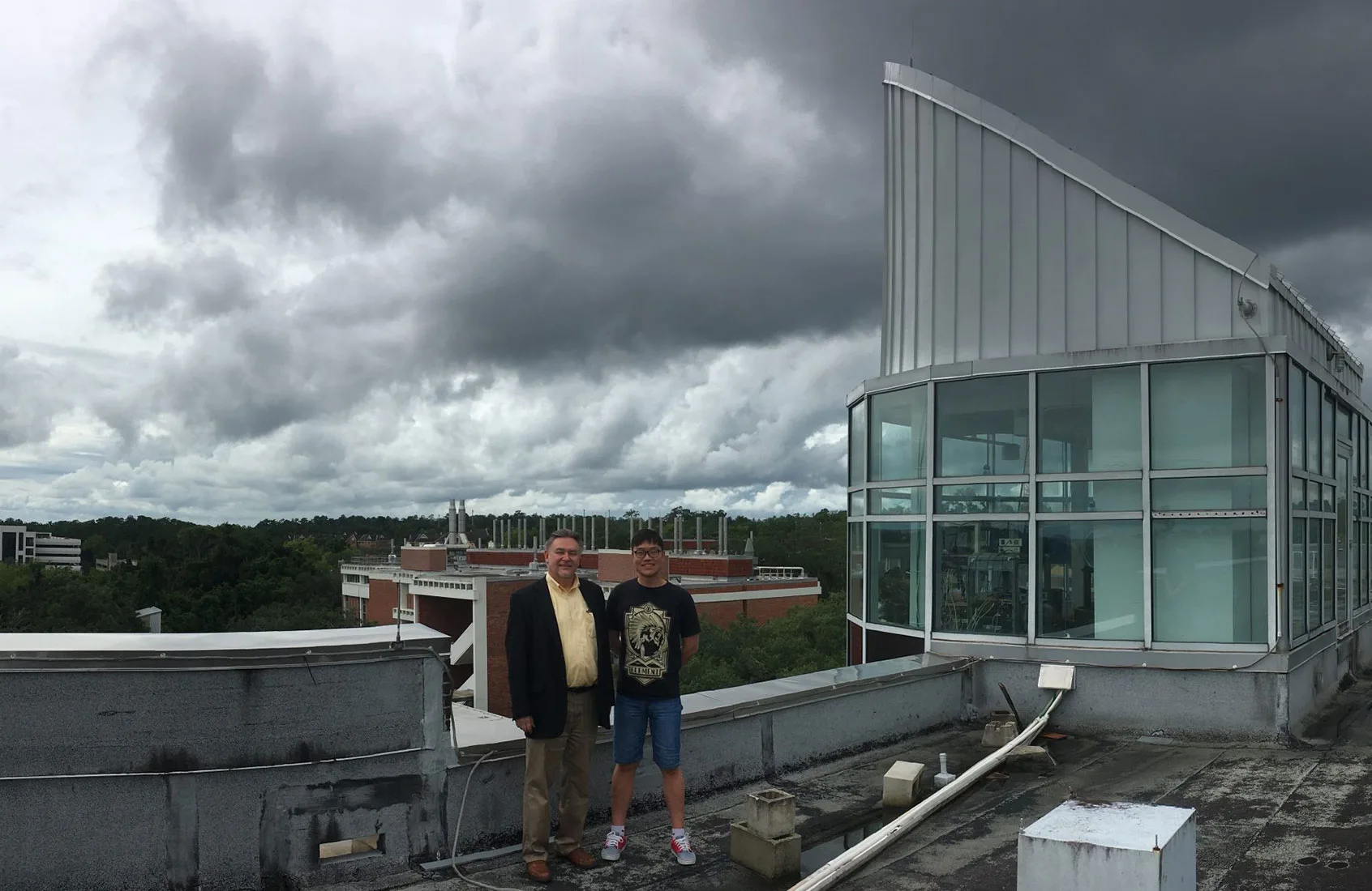 Distinguished Professor Vladimir Rakov, Ph.D., and Postdoctoral Researcher Ziqin Ding Ph.D., atop the New Engineering Building near the LOG Cupola