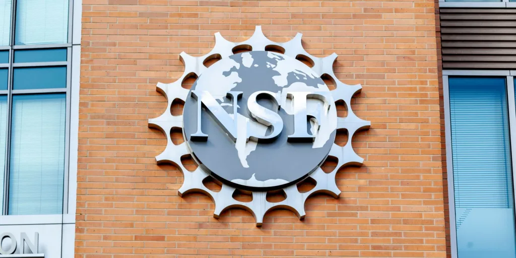 The logo for the National Science Foundation at the side of a brick building