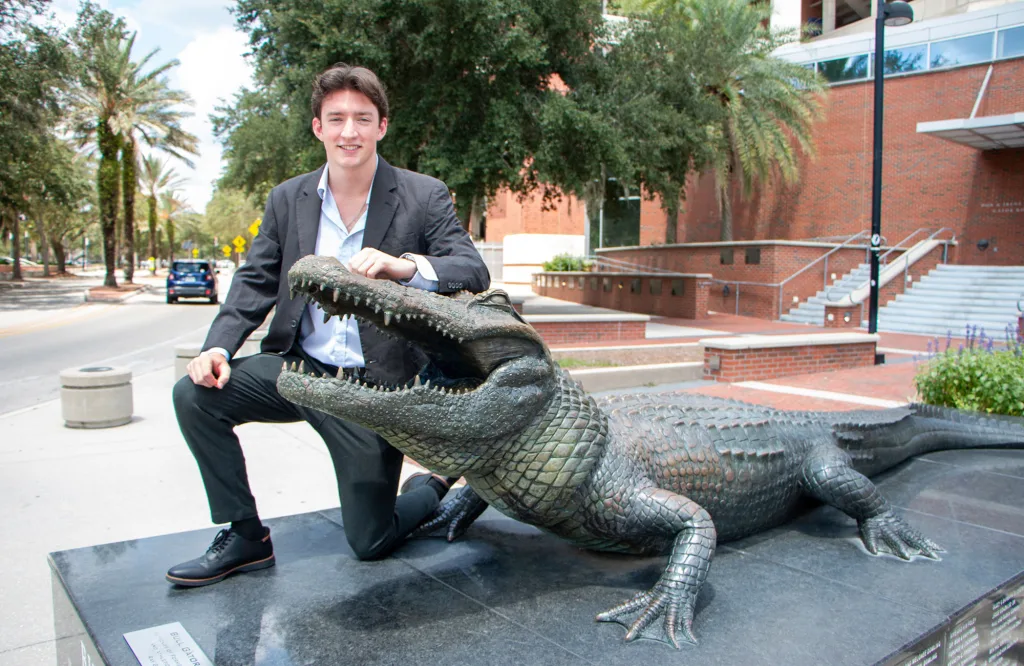 ECE senior Hudson Marr posing next to the Bull Gator on UF's campus