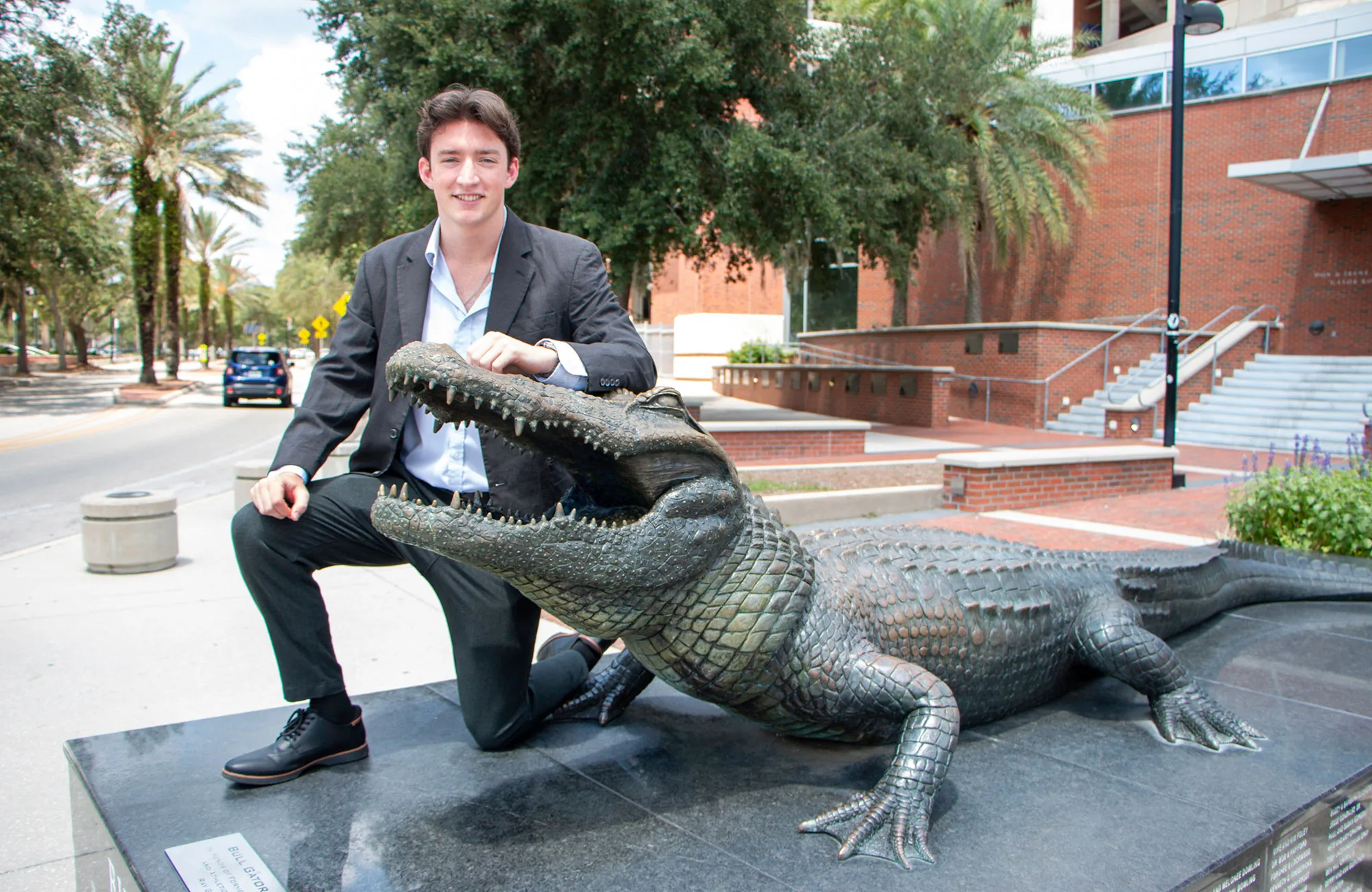 ECE senior Hudson Marr posing next to the Bull Gator on UF's campus